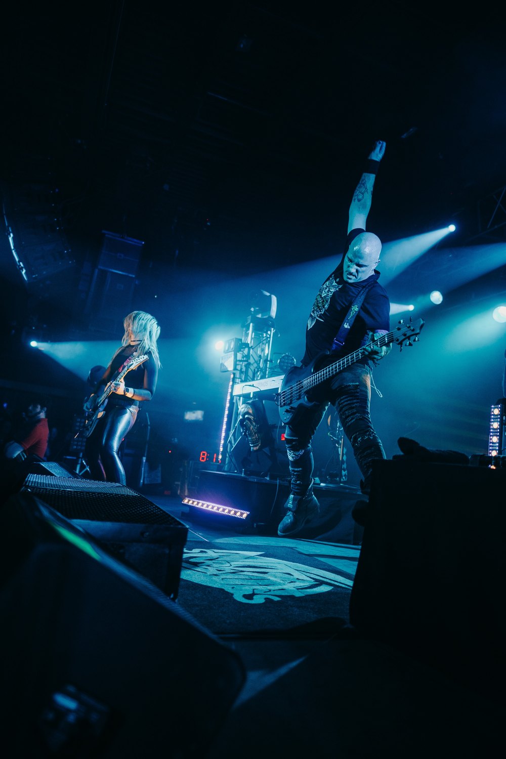 Dean mid-air on stage with Nita Strauss