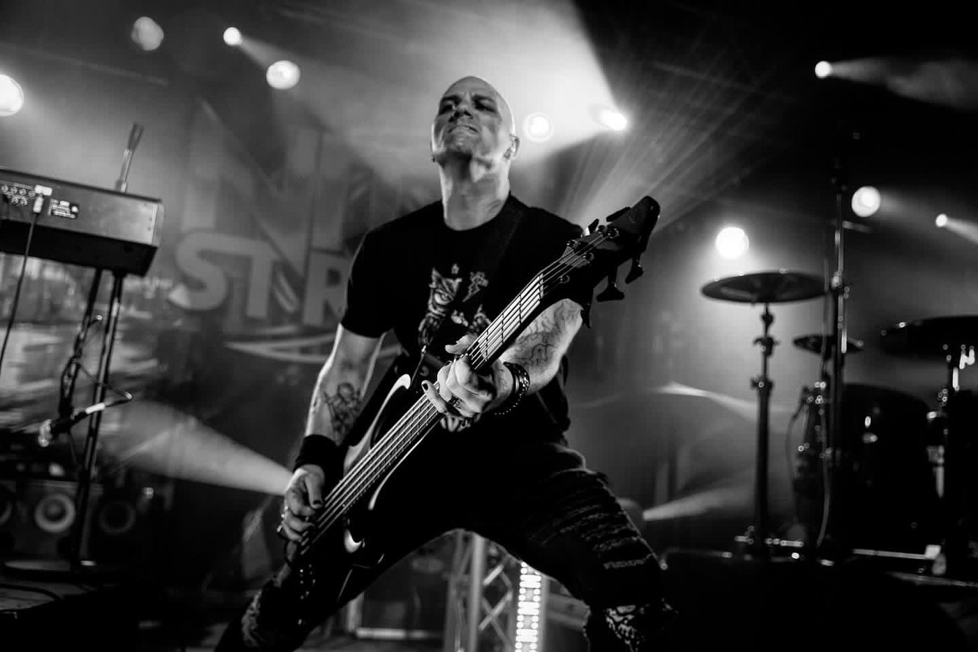 Dean playing bass on stage under white light