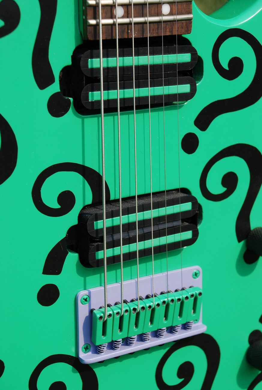 Close up of the question-mark finish, pickups and bridge