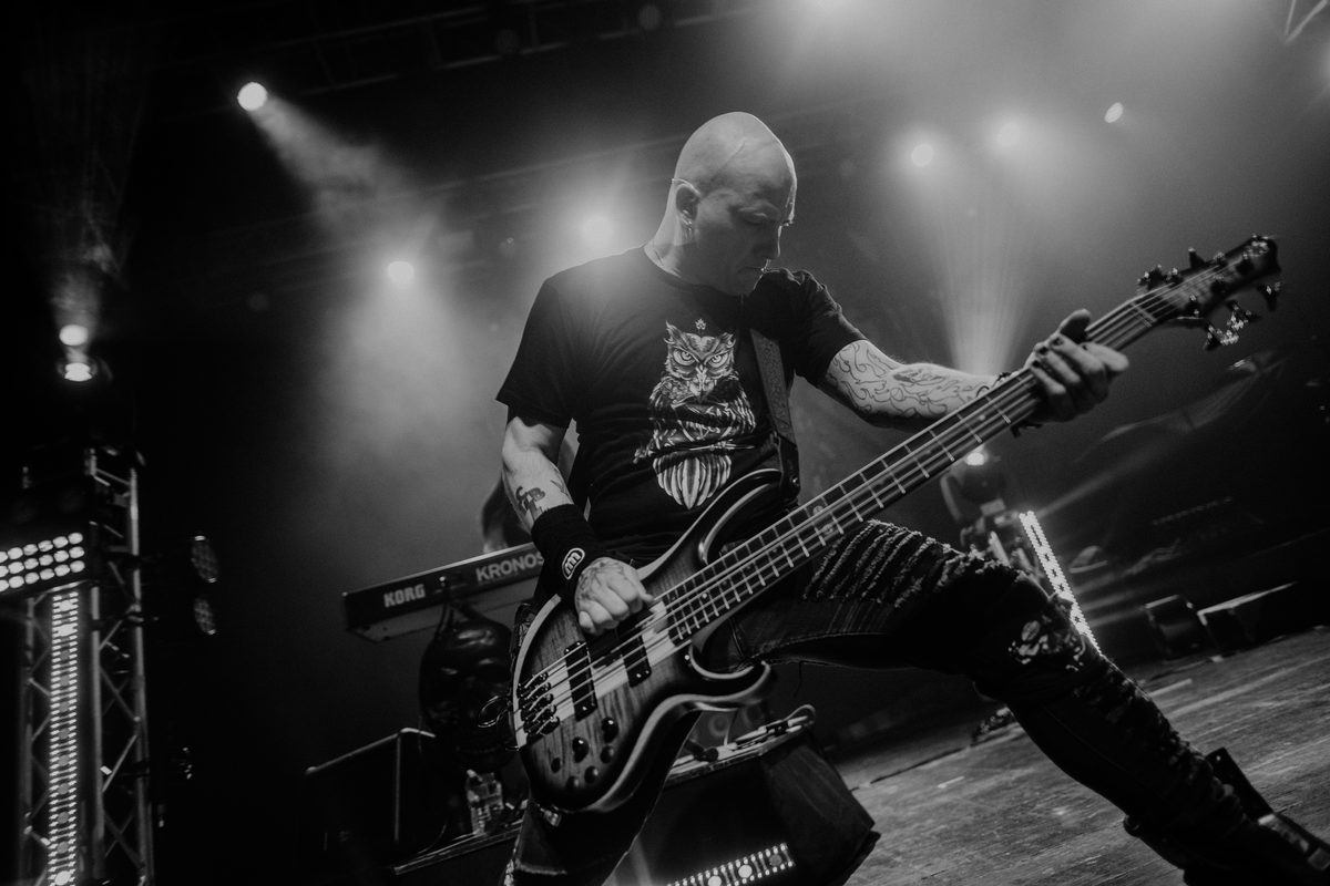 On stage with a five-string bass, black and white
